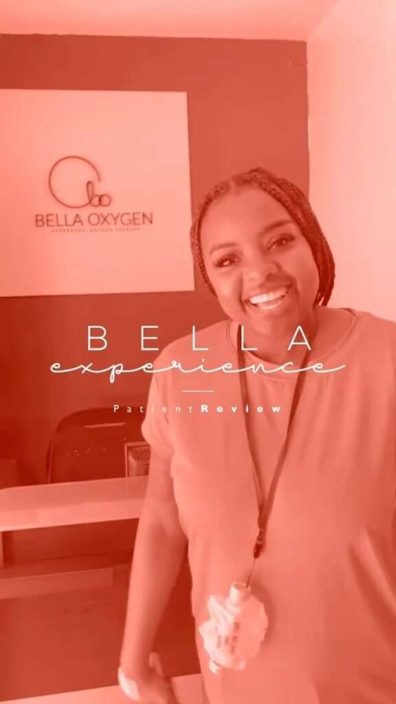 Patient standing beside the Bella Oxygen clinic sign