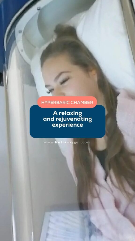Patient resting inside the clear Bella Oxygen hyperbaric chamber